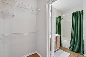 Walk-in closet with wire shelving and bathroom view